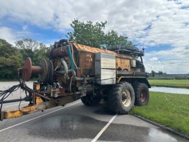 Tractor sludge suction unit