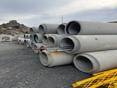Various concrete products and pipes, sold together.