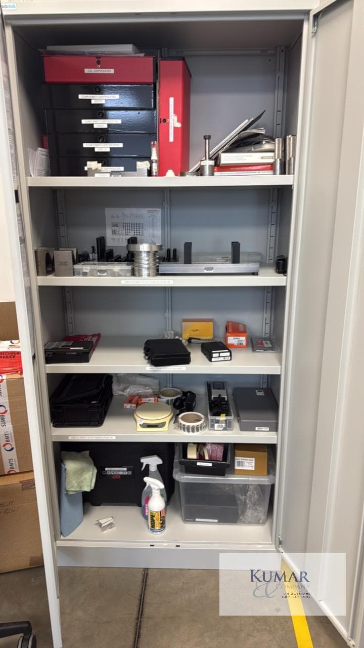 Bisley double-door steel lab cabinet containing CMM fixtures, metrology equipment & calibration archive